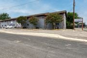 San Antonio apartment for rent - a large white building with trees in front of it on a street at The Crossings at Montrose Apartments, Texas, 78223