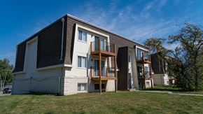 Grandview apartment for rent - A modern two-story residential building with a balcony on the second floor.