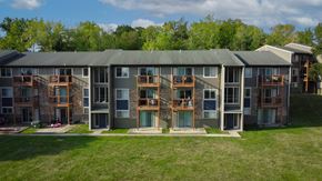 Gladstone apartment for rent - A large building with a green roof and a balcony on the second floor.