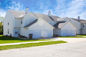 Belton townhouse for rent - a white house with two garage doors and a sidewalk