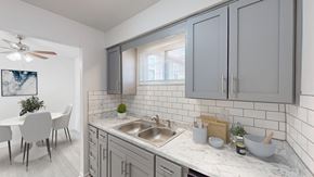 Gladstone apartment for rent - an open kitchen and dining room with a table and a sink
