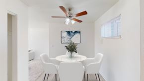 Gladstone apartment for rent - a dining room with a table and chairs and a ceiling fan