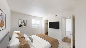 Gladstone apartment for rent - a bedroom with a bed and a tv on the wall