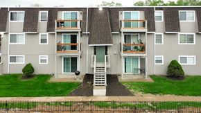 Kansas City apartment for rent - an exterior view of an apartment building with stairs and grass