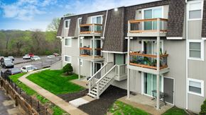 Kansas City apartment for rent - an aerial view of an apartment building with balconies and a lawn