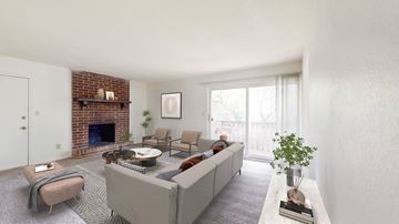 Overland Park apartment for rent - a living room with a white couch and a brick fireplace