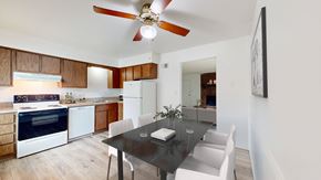 Overland Park apartment for rent - a kitchen and dining room with white appliances and a black dining table