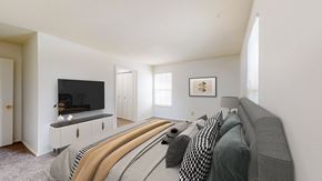 Overland Park apartment for rent - a bedroom with a large bed and a tv in the corner