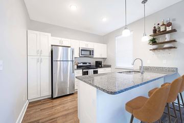 Overland Park apartment for rent - A kitchen with a granite countertop and a refrigerator.