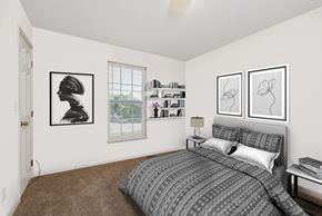 Gardner apartment for rent - A bedroom with a bed, nightstand, and two framed artworks on the wall.
