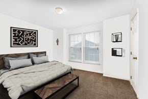 Gardner apartment for rent - A bedroom with a large bed and a picture on the wall.