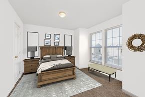 Gardner apartment for rent - A bedroom with a bed, nightstands, and pictures on the wall.