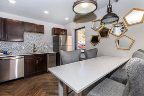 Kansas City apartment for rent - A kitchen with a table and chairs and a refrigerator.