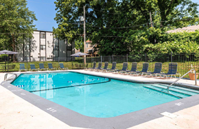 Kansas City apartment for rent - A rectangular swimming pool with a black fence around it.