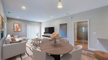 Lawrence townhouse for rent - A modern living room with a wooden table and white chairs.
