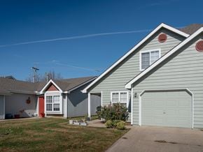 Lawrence townhouse for rent - A house with a grey siding and a red door is shown.