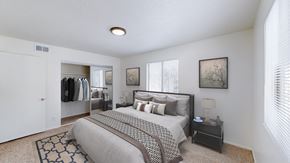 Kansas City apartment for rent - A bedroom with a large bed and a clothing closet.