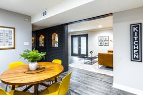 Grandview apartment for rent - a dining room with a wooden table and yellow chairs