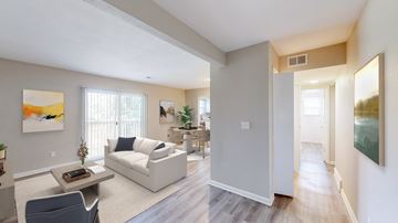 Overland Park apartment for rent - A living room with a white couch and a painting on the wall.