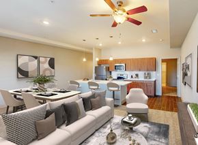 Overland Park apartment for rent - A modern living room with a white sofa and a dining table.