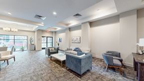 Overland Park apartment for rent - A living room with a grey sofa and a wooden table.