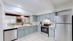 Lawrence townhouse for rent - A kitchen with a refrigerator, sink, and oven.