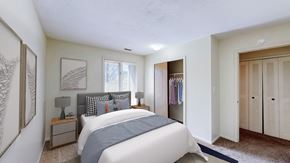 Lawrence townhouse for rent - A bedroom with a large bed and a window.