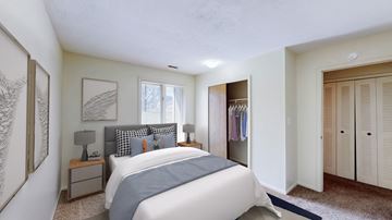 Lawrence townhouse for rent - A bedroom with a large bed and a window.