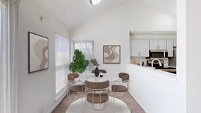 Olathe apartment for rent - A dining room with a white table and chairs.