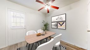 Olathe townhouse for rent - A dining room with a table, chairs, and a ceiling fan.