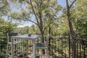 Kansas City apartment for rent - a table and chairs on a balcony with trees