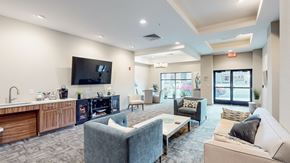 Overland Park apartment for rent - A modern living room with a kitchen area in the background.