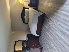 Valparaiso apartment for rent - A bedroom with a bed, nightstand, and mirror.