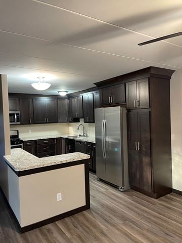 Valparaiso apartment for rent - A kitchen with dark brown cabinets and a granite countertop.