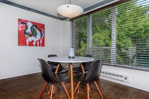 Lafayette apartment for rent - A dining room with a table and chairs and a painting on the wall.