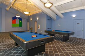 Bloomington apartment for rent - A pool table with a blue cloth and a pool table with a brown cloth.
