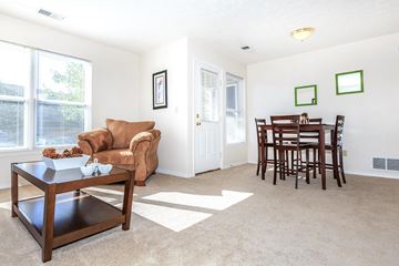 Bloomington apartment for rent - A living room with a brown chair and a coffee table.