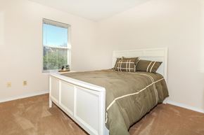 Bloomington apartment for rent - A bedroom with a large bed and a window.