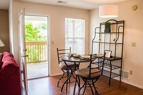 Bloomington apartment for rent - A dining room with a table set for two and a red couch.