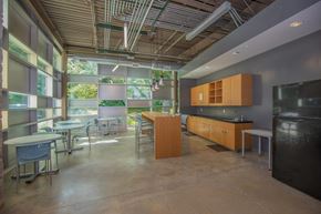 Bloomington apartment for rent - A kitchen with a black refrigerator and wooden cabinets.