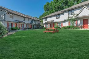 Bloomington apartment for rent - A grassy area in front of a building with a picnic table.