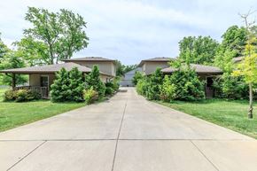 Bloomington apartment for rent - A residential area with two houses and a driveway.