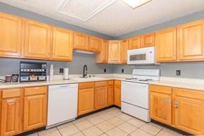 Lafayette apartment for rent - A kitchen with wooden cabinets and white appliances.