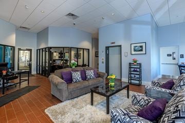 Lafayette apartment for rent - A living room with a grey couch and a black coffee table.