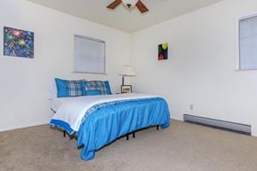 West Lafayette apartment for rent - A bedroom with a bed covered in a blue bedspread.
