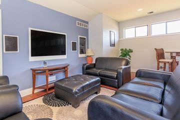 West Lafayette apartment for rent - A living room with a black leather couch and a wooden coffee table.