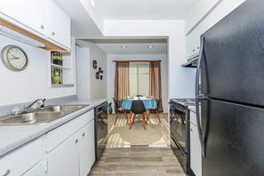 West Lafayette apartment for rent - A kitchen with a black refrigerator and a dining table with chairs.