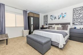 West Lafayette apartment for rent - A bedroom with a large bed and a bench.
