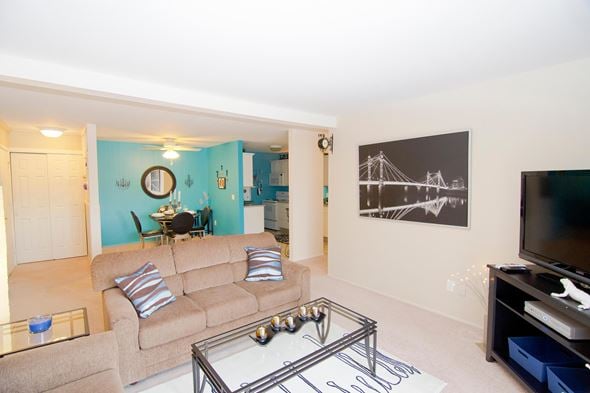 Lansing townhouse for rent - A living room with a tan couch and a glass coffee table.