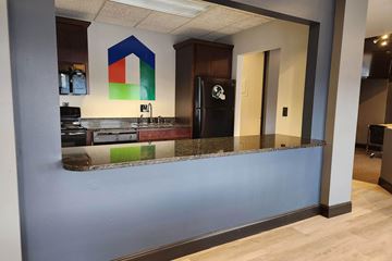 East Lansing townhouse for rent - A kitchen with a blue counter and a black fridge.